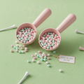 Two Par-Tee Prize Bead Scoops with pastel beads in pink, mint, and pearl